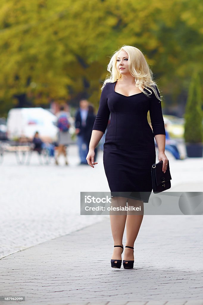 attractive overweight woman walking the city street Plus Sign Stock Photo