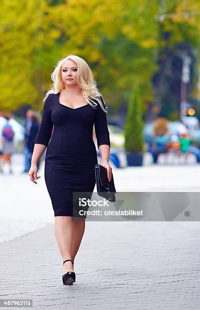 Confident Overweight Woman Walking The City Street Stock Photo - Download Image Now - Blond Hair, Confidence, One Woman Only