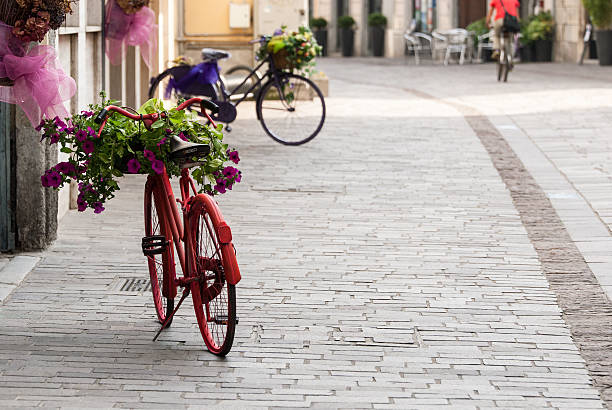 Bicycles with baskets full of colorful flowers in Milan.