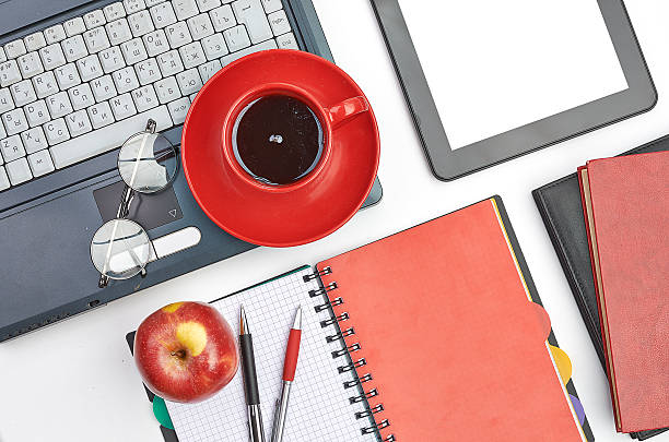 istock Laptop and office supplies on white 487962953