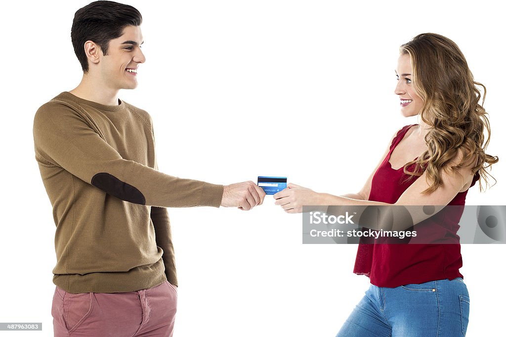 Girlfriend sweetly snatching credit card Pretty girl taking away credit card to shop Credit Card Stock Photo