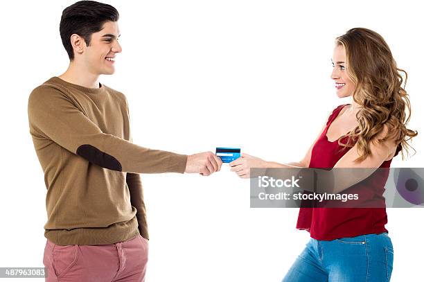 Girlfriend Sweetly Snatching Credit Card Stock Photo - Download Image Now - Credit Card, Friendship, Giving