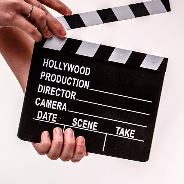 istock Movie flapper in woman´s hands on white background 487963715