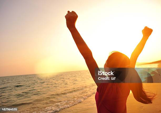 Cheering Woman Open Arms To Sunset At Seaside Stock Photo - Download Image Now - Beach, Exercising, People