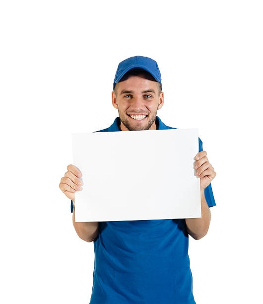 Young attractive courier guy holding placecard stock photo