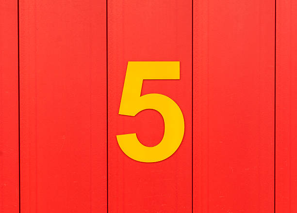 istock Yellow number five icon, against red wood 487967456