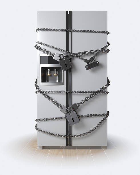 Dieting concept. Refrigerator, chain and lock stock photo