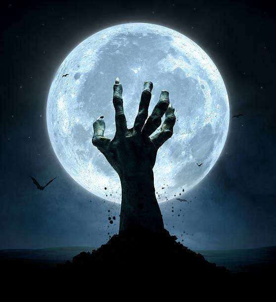 Halloween Halloween concept, zombie hand coming out from the grave monster back lit halloween cemetery stock pictures, royalty-free photos & images