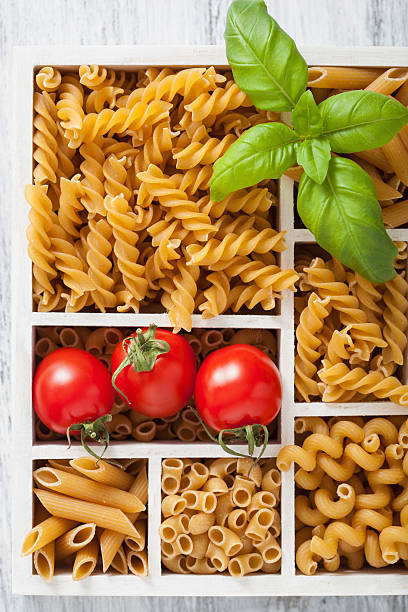 istock various raw wholegrain pasta in white wooden box 487972730