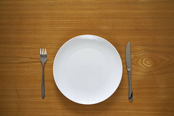 istock Empty porcelain plate on a wooden table top 487975476
