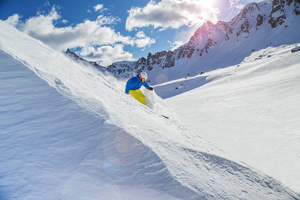 istock Skier skiing downhill in high mountains 487976450