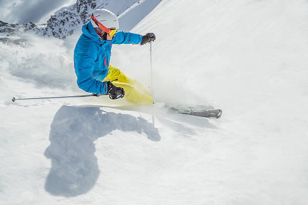 istock Skier skiing downhill in high mountains 487976518