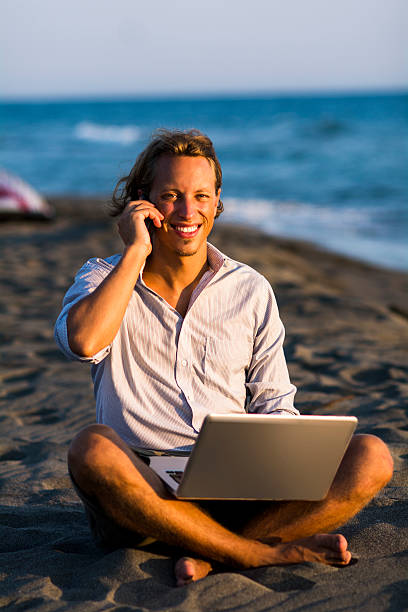 istock Young businessman on the beach 487976842