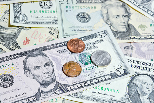 istock American Dollar bills with coins 487977448