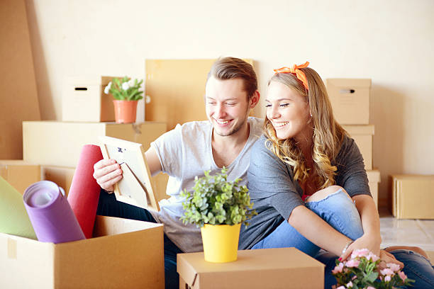 istock young couple in a new apartment with boxes for moving 487977902