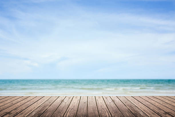 istock wooden floor with sea and sky blurred background 487979890