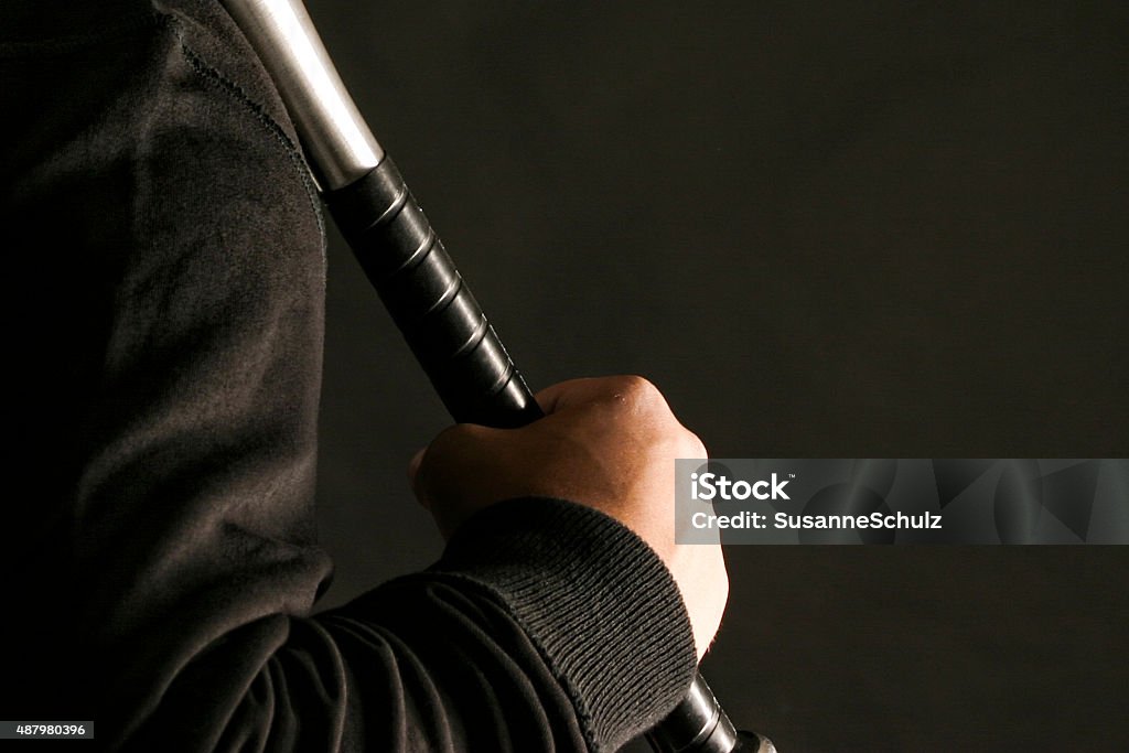 Man holding baseball bat Nazi with baseball bat on black hitter ground Metal Stock Photo