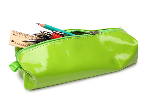 Pencil case with school supplies on white background