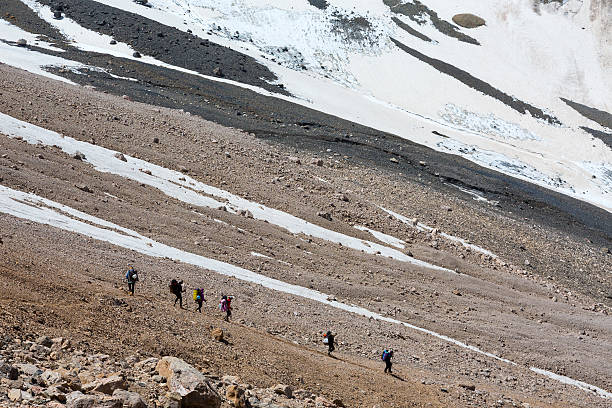 istock Group of Hikers Walking on Deserted Rocky Terrain 487980894