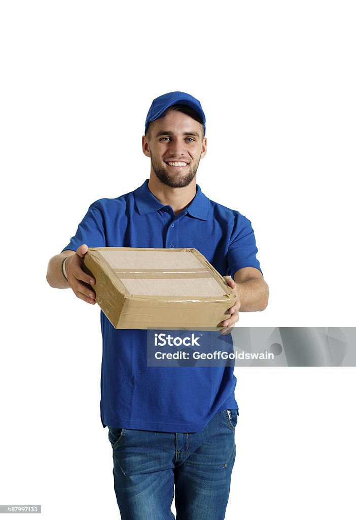 Young attractive delivery guy delivering brown box parcel Adult Stock Photo