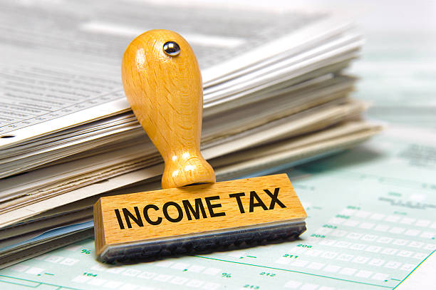 income tax income tax marked on rubber stamps income tax stock pictures, royalty-free photos & images
