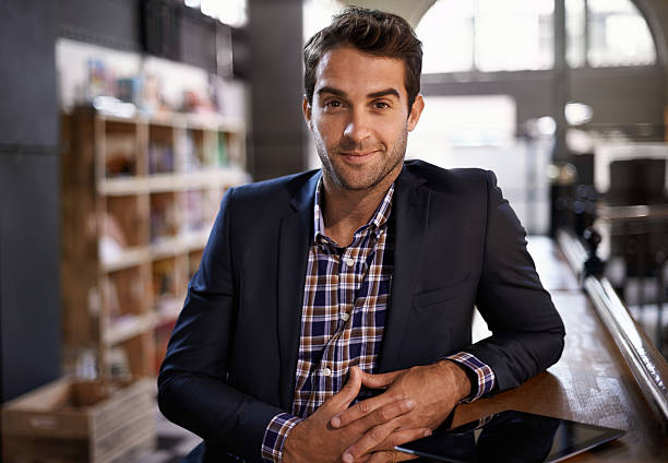 Welcome to my pub Portrait of a handsome young man standing next to a bar counter man 30 years old stock pictures, royalty-free photos & images