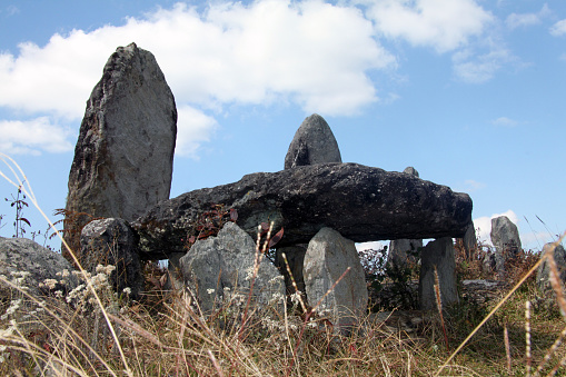 A stone seat surrounded by standing stones is on a hillside at Mawphlang sacred forest in Meghalaya, northeastern India
