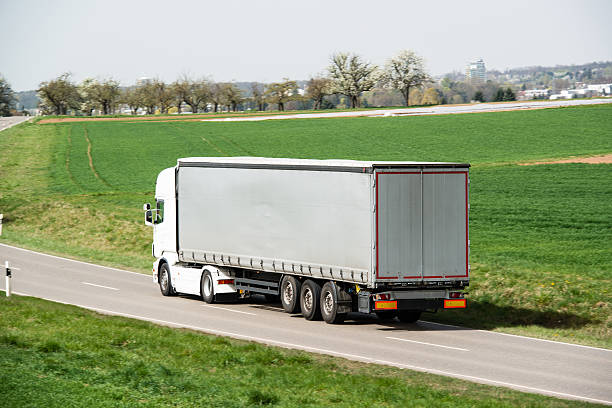 istock White truck moving on a main road 488002217