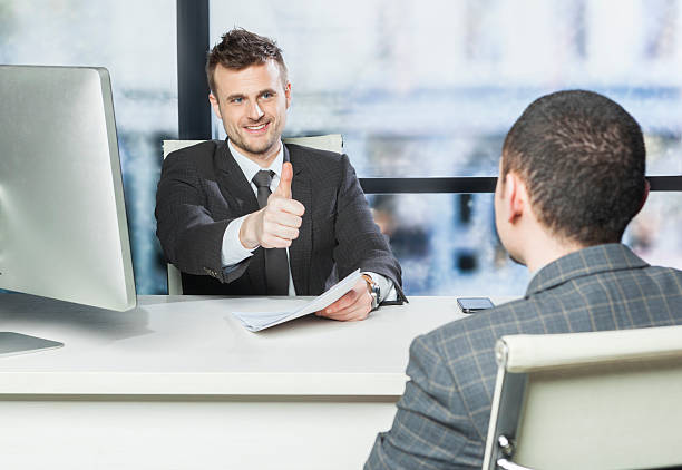 Successful job interview - getting thumbs up from manager stock photo