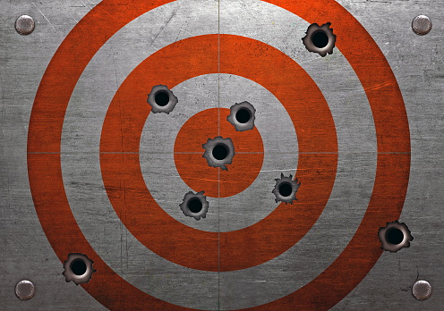 Target with bullet holes, grunge background