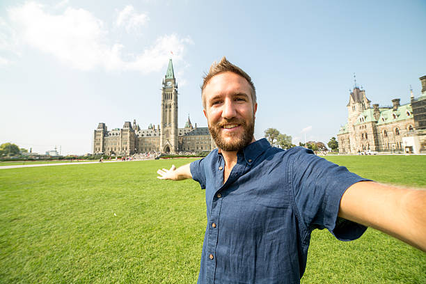 istock Young cheerful man in Ottawa-Canada taking a selfie portrait 488002852