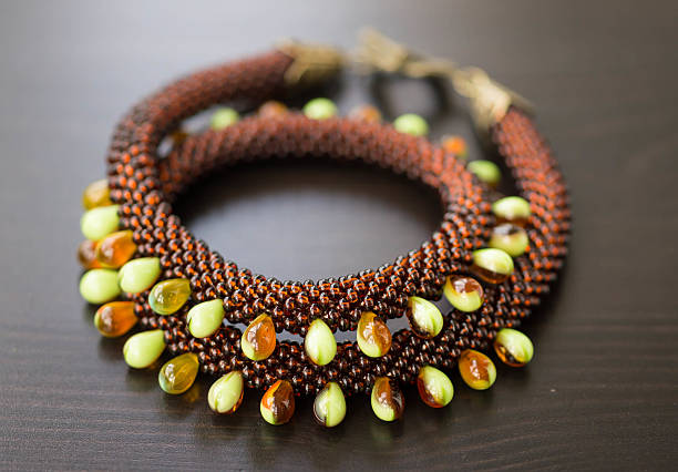 istock Knitted necklace from different types of beads close up 488002857