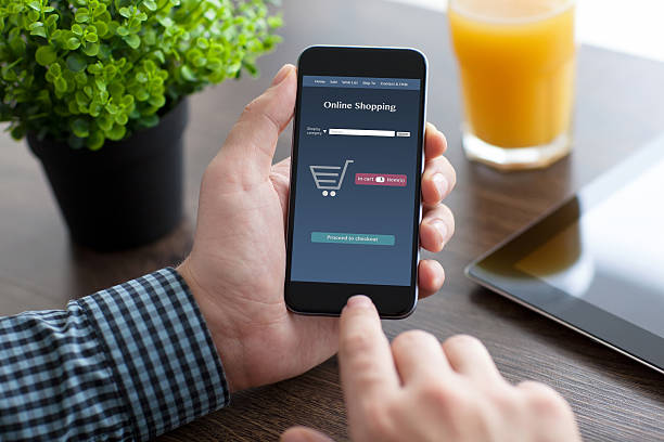istock man holding phone with app online on the screen 488003432