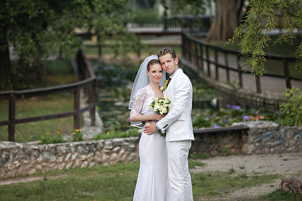 istock Happy wedding couple in a park 488003482