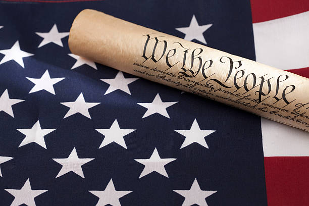 istock United States Constitution and American Flag 488003991