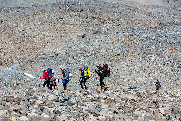 istock Group of people walking on rocky trail 488004460