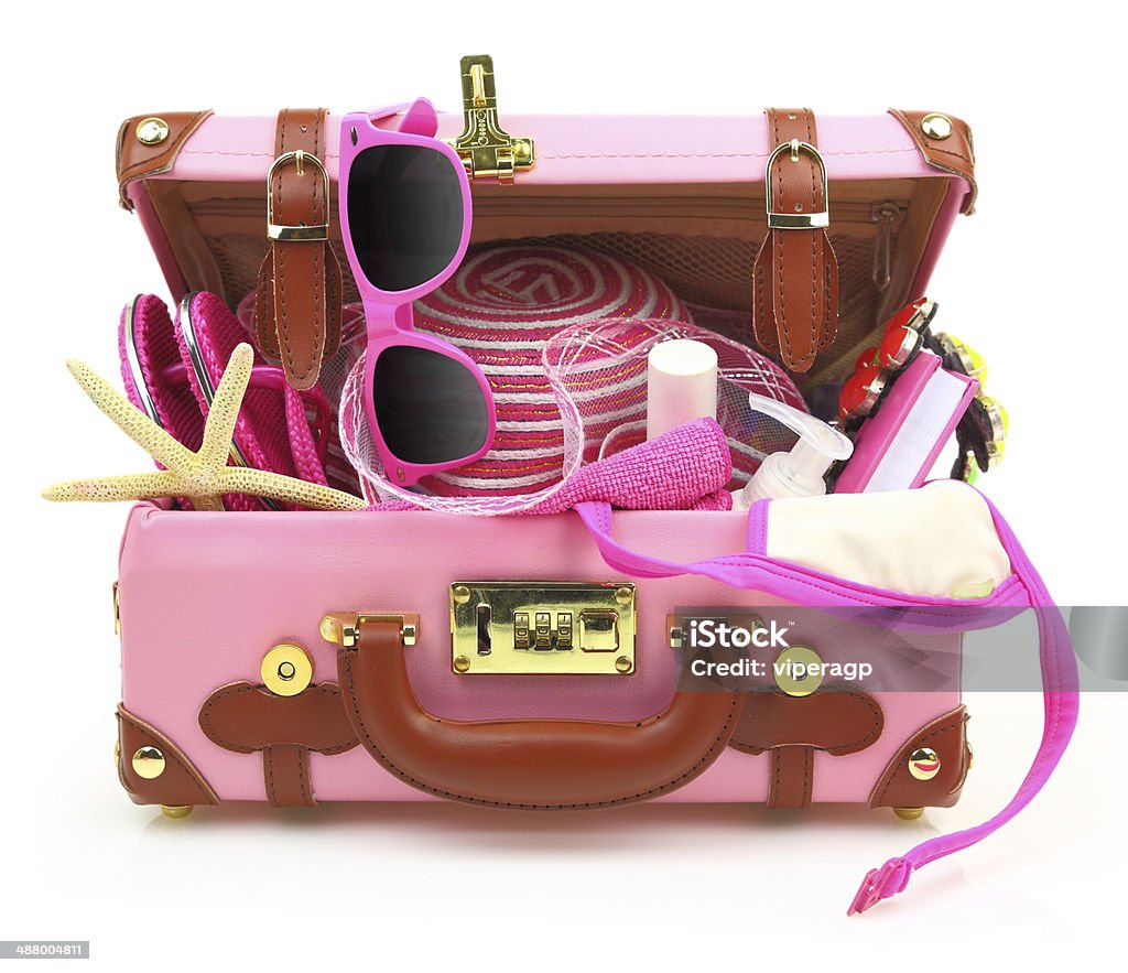 Ready to travel pink suitcase with summer equipment isolated Crowded Stock Photo
