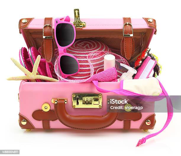 Ready To Travel Pink Suitcase With Summer Equipment Isolated Stock Photo - Download Image Now