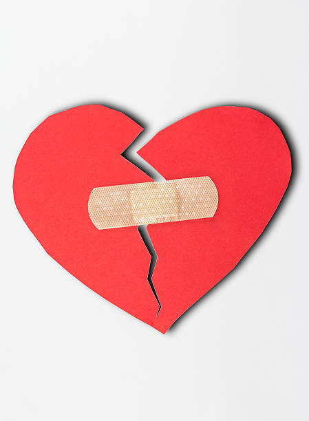 istock close up of plaster and paper broken heart  white background 488007784