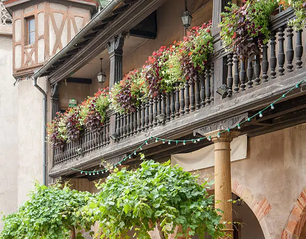 detail of a wooden balcony seen in Colmar, Alsace, France