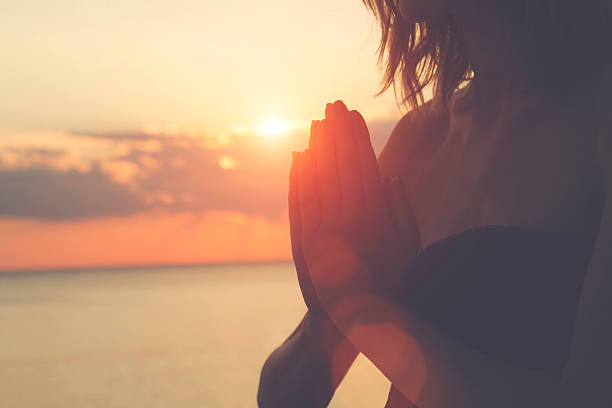 istock Young woman practicing yoga on the beach. 488010072