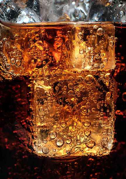 istock Bubbles in the glass of cola with ice. 488011846