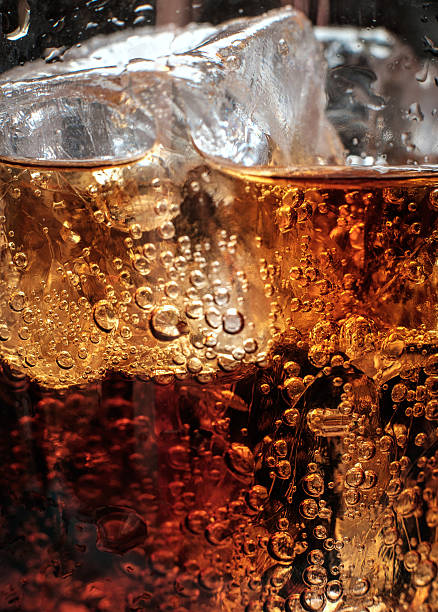 istock Bubbles in the glass of cola with ice. 488011912