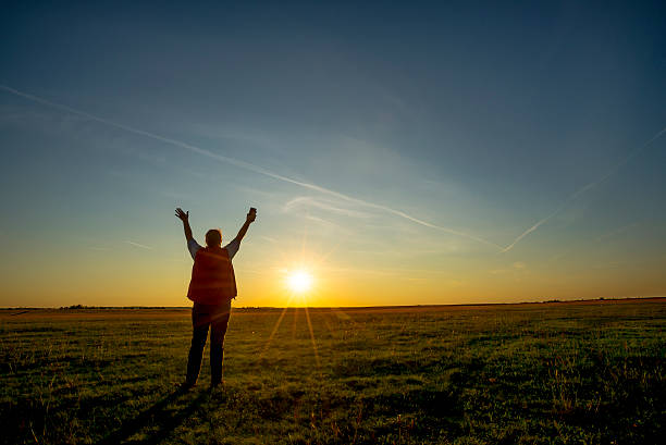 istock Woman with arms extended in the field 488013342