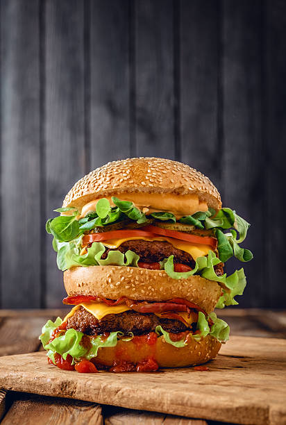 istock Home made double burger on wooden background 488014962