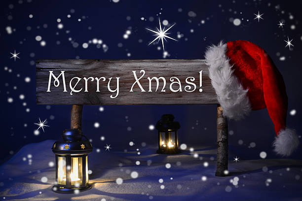 istock Christmas Sign Candlelight Santa Hat Merry Xmas 488015274