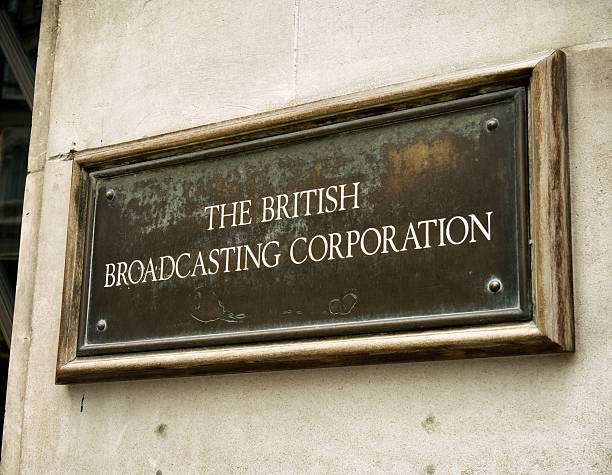 The British Broadcasting Corporation - sign London, England - September 8, 2015: An old-fashioned metal plaque outside Broadcasting House, home of the British Broadcasting Corporation (the BBC) in Langham Place, Central London. The building to which it is attached was opened in 1932 and is in Art Deco style, faced with Portland Stone. The postcode for Broadcasting House is W1A 1AA. bbc photos stock pictures, royalty-free photos & images