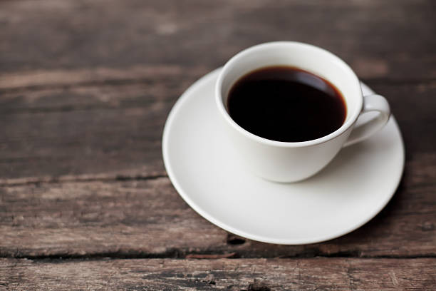 istock Cup of coffee on wooden table 488026461