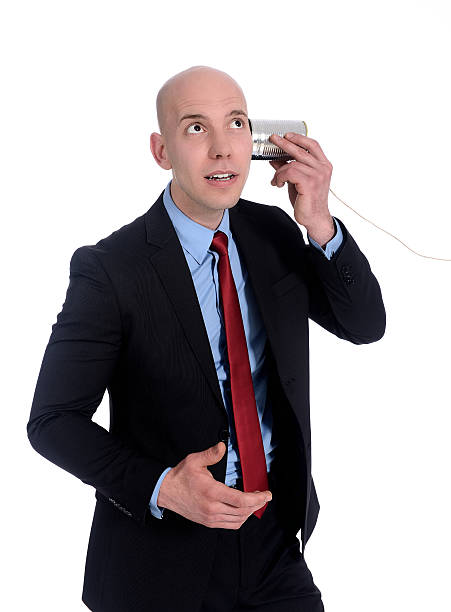 Two Asian Muslim people using a homemade cup-and-string telephone during an Eid celebration. Isolated on a white background. Nostalgia, communication, and message concept.