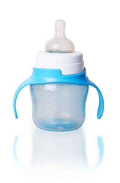 baby bottle with blue plastic handles baby bottle with blue plastic handles isolated on white background glass medicine blue bottle stock pictures, royalty-free photos & images